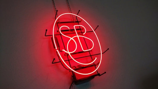  neon red sign with dark gray background.