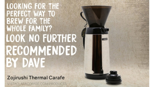 Tan background with white lettering next to a black and silver coffee carafe.